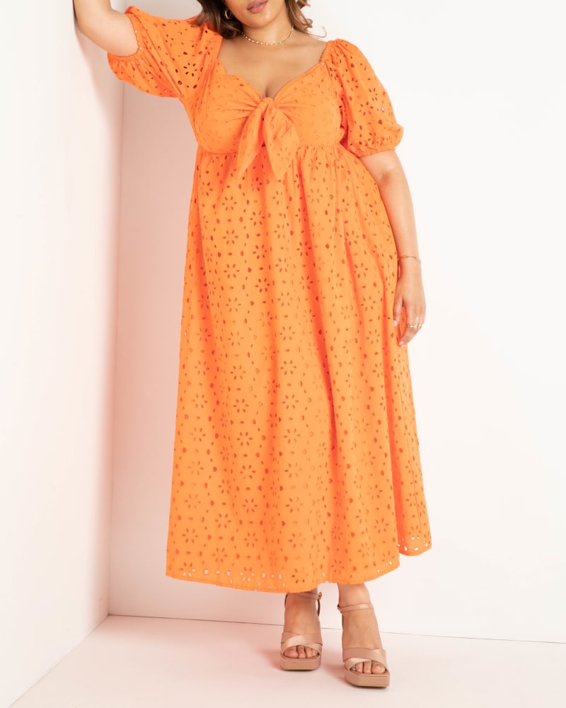 Front of a model wearing a size 14 Eyelet Tie Front Maxi Dress in Firecracker by ELOQUII. | dia_product_style_image_id:284295